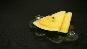 Yellow watermelon slices on a plate photo