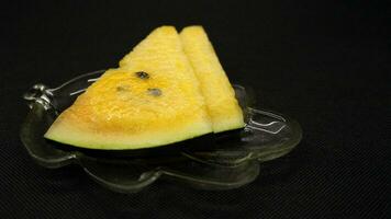 Yellow watermelon slices on a plate photo