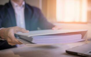 businessman hand holding or handing over document, documentation, document data management system, Document data system Report HR technology Concept photo