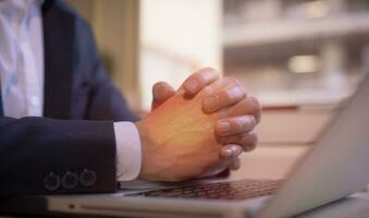 Hands of a thoughtful, hr recruiter making hiring decision at difficult job interview, opponents dialogue debate, business confrontation challenge concept, pray hope and negotiation business dealing photo