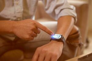 man pointing at wristwatch in a concept of time management schedule appointment meeting punctual photo