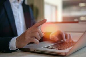 businessman using computer laptop presenting business data report, business meeting, marketing plans and strategy photo