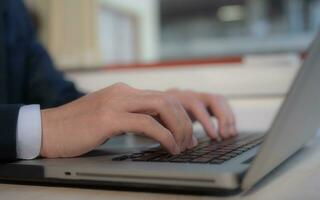 Businessman hands typing on laptop computer keyboard, surfing internet working in business concept.SEO, Search Engine Optimization, analysis financial data report, investment strategy and planning photo