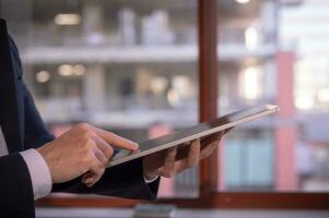 business and technology concept, social media working and life styles, businessman using digital tablet searching surfing on internet network, data analysis business online report photo