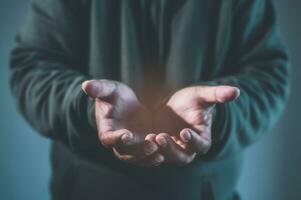 concept of hope helping hands, Praying hands with faith in religion and belief in God on blessing background. Power of hope or love and devotion. Magic powder floating on the magician hand photo