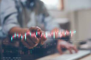 investment and financial concept, man pointing at virtual trading graph stock market data chart photo