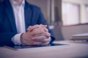 Hands of a thoughtful, hr recruiter making hiring decision at difficult job interview, opponents dialogue debate, business confrontation challenge concept, pray hope and negotiation business dealing photo