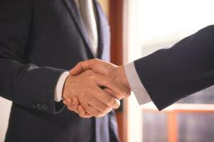 businessman shake hand with partner to celebration partnership and business deal concept, Businessman handshake for teamwork of business merger and acquisition, successful negotiate, hand shake photo
