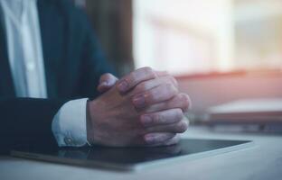 Hands of a thoughtful, hr recruiter making hiring decision at difficult job interview, opponents dialogue debate, business confrontation challenge concept, pray hope and negotiation business dealing photo
