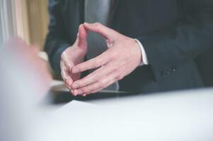 Body language concept, businessman standing with putting hands together showing positive thinking and calm photo