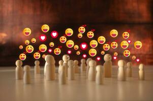 social society happyness concept, crowd of wooden people stand together with icons laugh happy and love photo