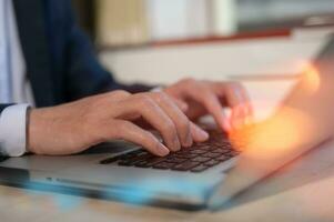 Businessman hands typing on laptop computer keyboard, surfing internet working in business concept.SEO, Search Engine Optimization, analysis financial data report, investment strategy and planning photo
