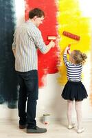 Father and daughter painting wall photo