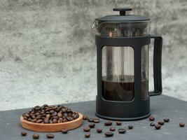 french press coffee maker pot and coffee beans photo