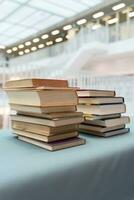 A stack of books lying on the table.  A lot of books are on the table. A large stack of books are collected in one place. photo