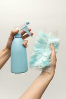 Plastic foggy sprayer bottle in hand isolated on white background. Spray bottle in hand on a white background. photo