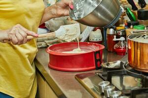 Chef adds the dough to the silicone pie mold photo