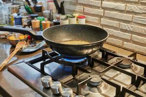 Caramelized syrup in frying pan on gas stove fire photo