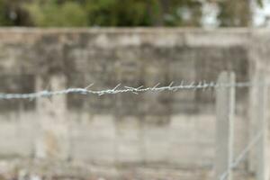 Barbed Wire on Blur Old Wall Background photo