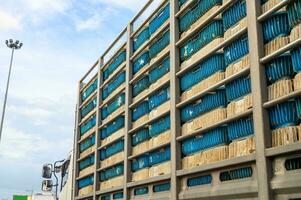 Chickens transportation in cramped cage stacked on a truck photo