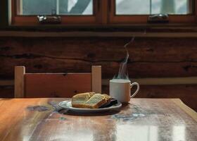 Served slice bread with hot espresso in a cup on  wooden lodge photo