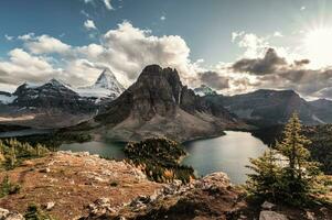 Mount Assiniboine with lake in autumn forest on Niblet peak at provincial park photo