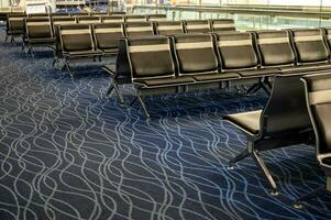 Row of passenger chairs in departure hall photo