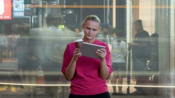 Woman with touch pad in crowded street photo