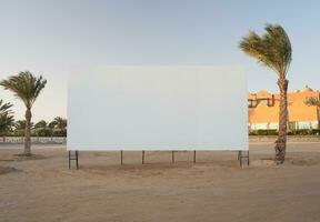 Blank billboard with palm trees photo