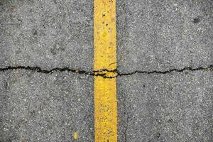 Crack on line yellow on road texture photo