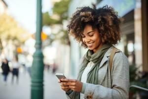 Beautiful black woman holding her cell phone with fingers on the screen photo