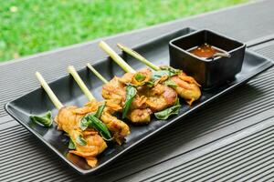 Chicken roast turmeric wrap lemongrass vegetable herb with spicy sour sauce thai food plate cup black photo