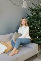 Happy young woman celebrates Christmas alone and is happy alone with herself photo