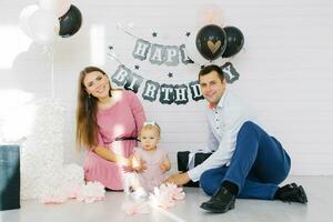 A beautiful family is celebrating their daughter's first birthday. Photo zone for a holiday
