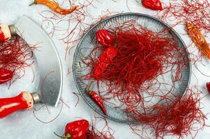 Cutting red chilly peppers. photo