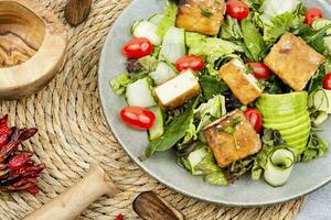 Salad with fresh vegetables and tofu. photo