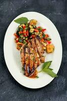 Tuna steak fried with grilled vegetables. photo