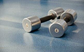 dumbbell, dumbbell in the gym on a blue background. gym for fitness. exercise equipment in the gym. photo
