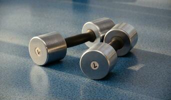 dumbbell, dumbbell in the gym on a blue background. gym for fitness. exercise equipment in the gym. photo