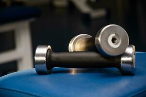 dumbbell, dumbbell in the gym on a blue background. gym for fitness. exercise equipment in the gym. photo