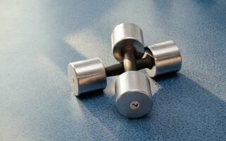 dumbbell, dumbbell in the gym on a blue background. gym for fitness. exercise equipment in the gym. photo