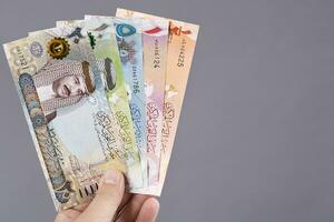 Bahraini money in the hand on a gray background photo