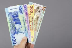 Sudanese money in the hand on a gray background photo