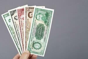 Old Paraguayan moneyi in the hand on a gray background photo