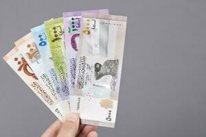 Syrian money in the hand on a gray background photo