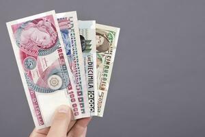 Old Italian money in the hand on a gray background photo