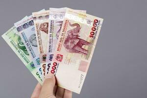 Tanzanian money in the hand on a gray background photo