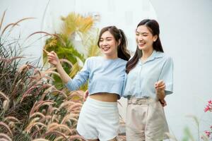 happy asian woman and friend in garden. photo