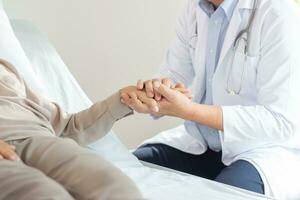 male doctor discussing over medical record with senior woman in hospital. photo