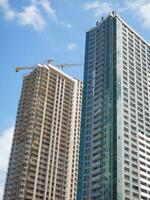 Modern multistory buildings under construction. Unfinished skyscrapers. photo